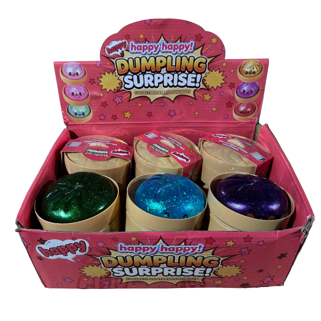 Box of 'Happy Happy Dumpling Surprise' toys with colorful dumplings inside, on a cardboard surface.
