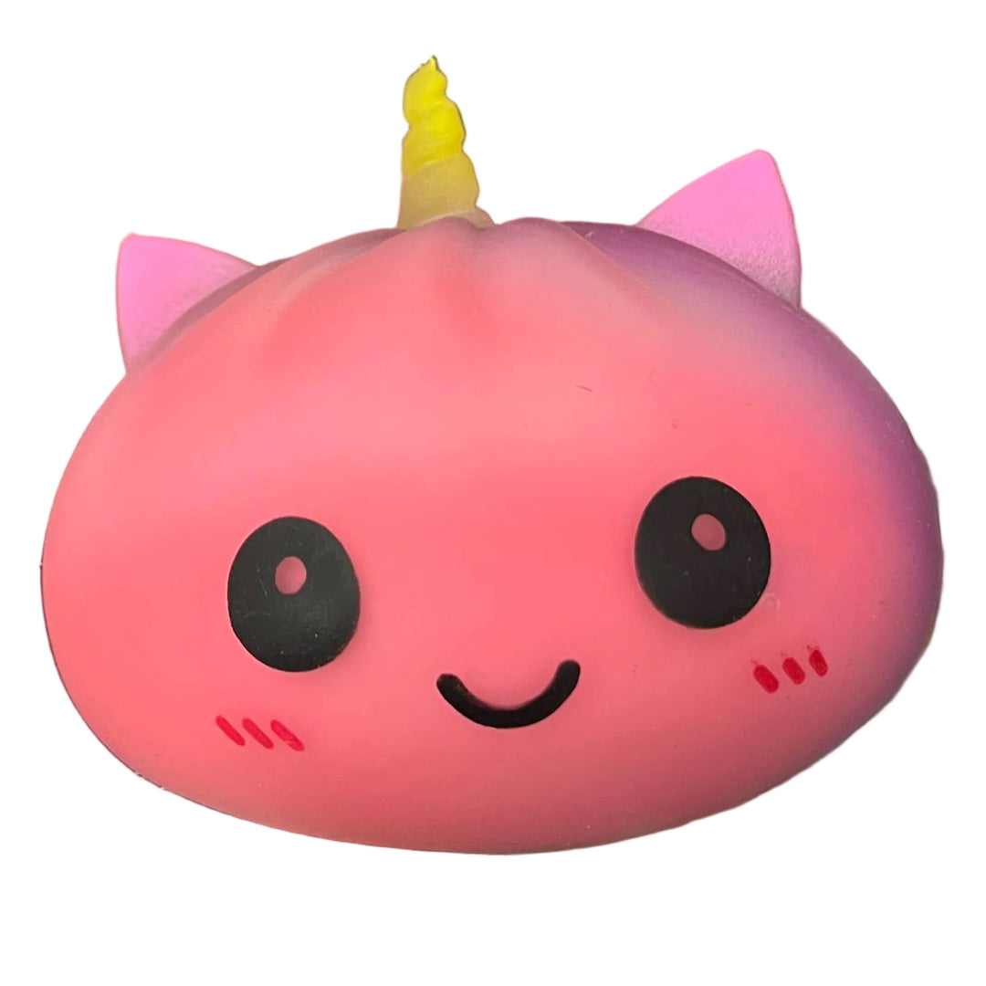 Pink cartoon-like toy held in a hand with a store shelf in the background