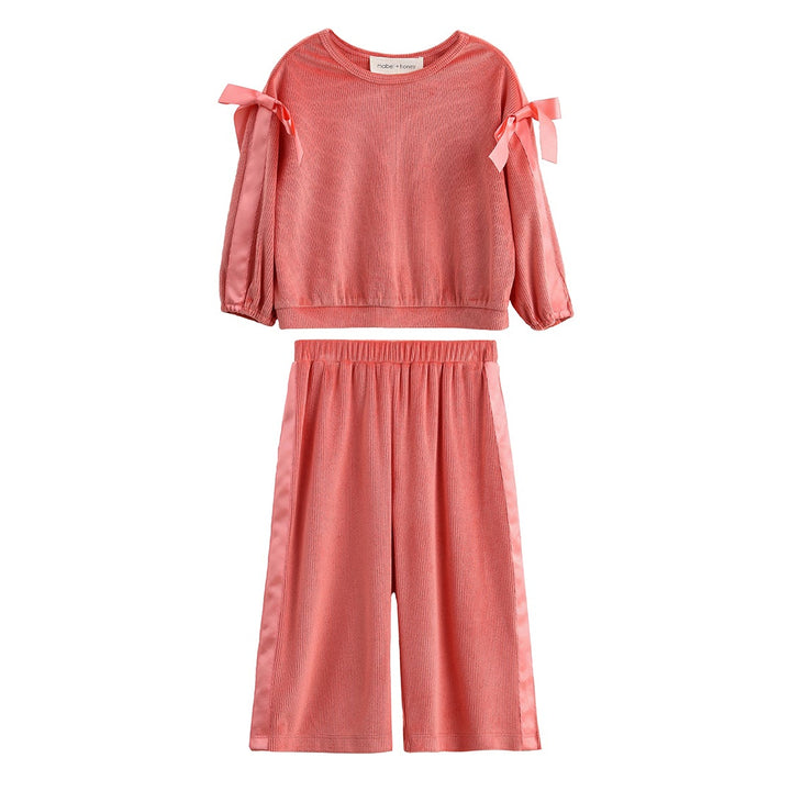 A two-piece children's outfit set in a dusty coral pink color, featuring a long-sleeve top with cold-shoulder bow details and matching wide-leg shorts, displayed on a solid white background.