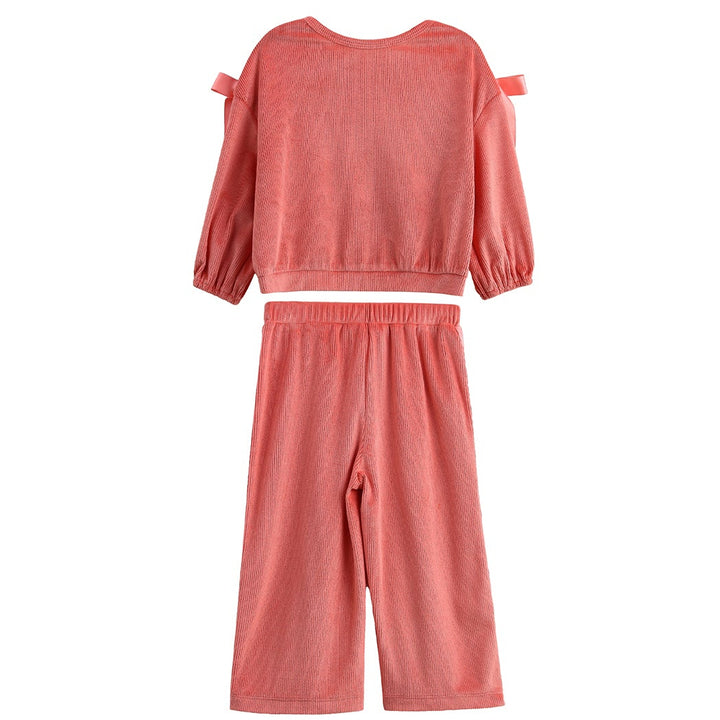 A two-piece children's outfit set in a dusty coral pink color, featuring a long-sleeve top with shoulder cutouts and matching wide-leg pants, shown against a plain white background.