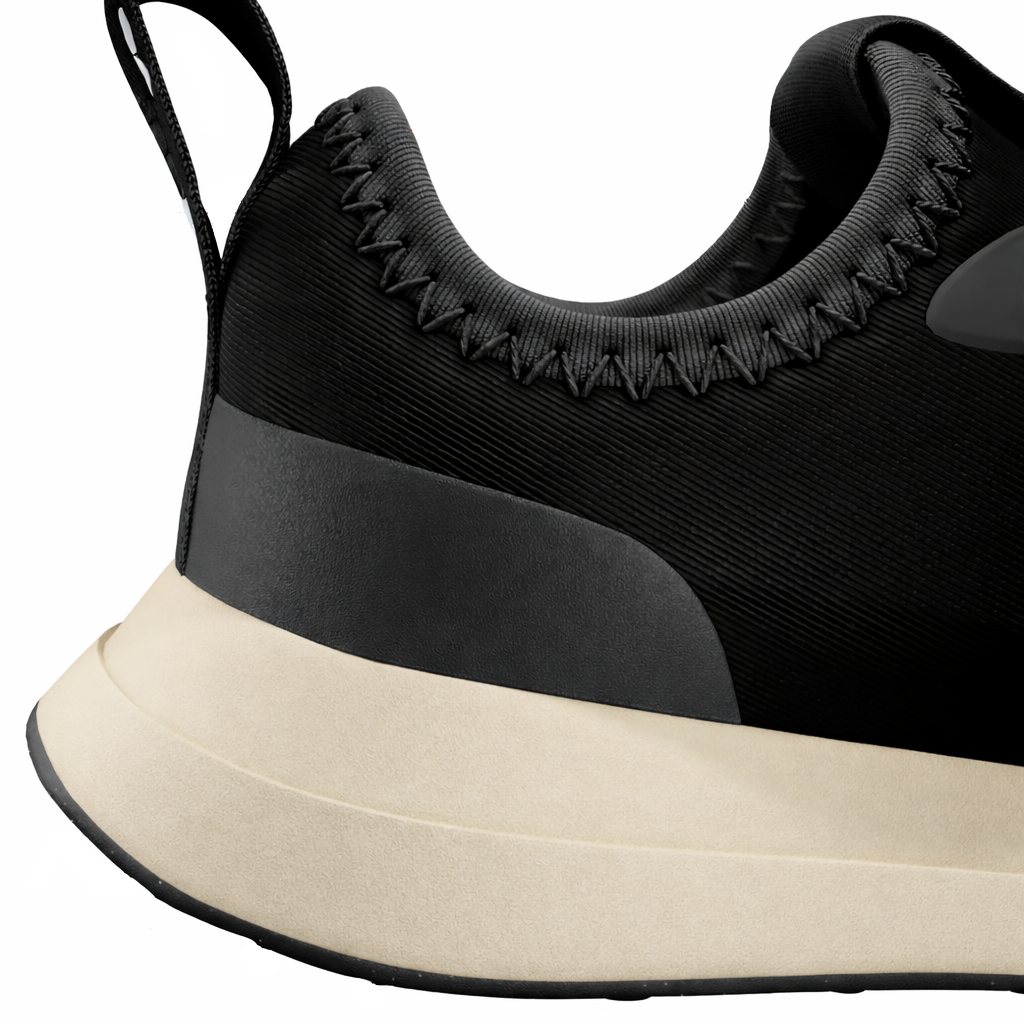 Black sneaker with beige sole on a white background