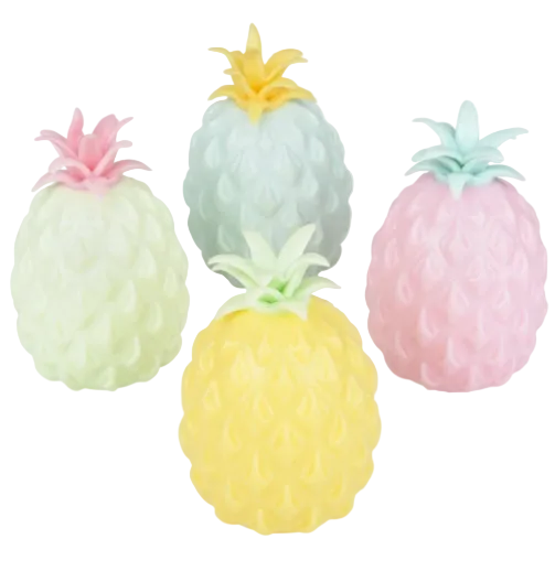 Set of four pineapple-shaped bath bombs in pastel colors on a white background