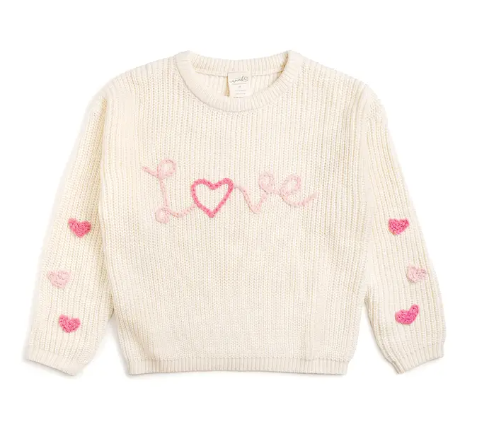 Cream-colored sweater with 'LOVE' text and heart patterns on a white background