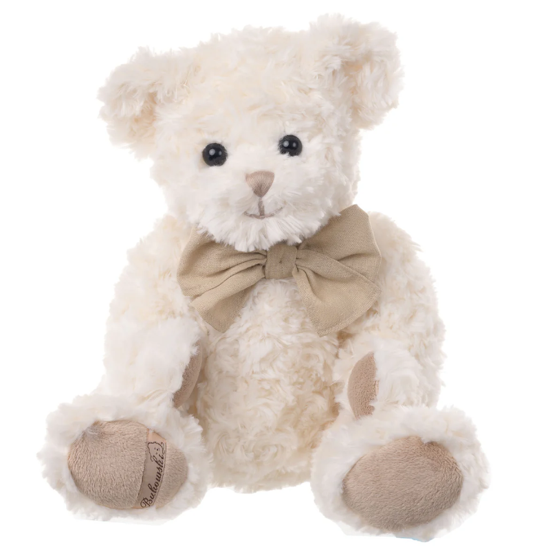 White Bukowski teddy bear with a beige bow tie on a white background