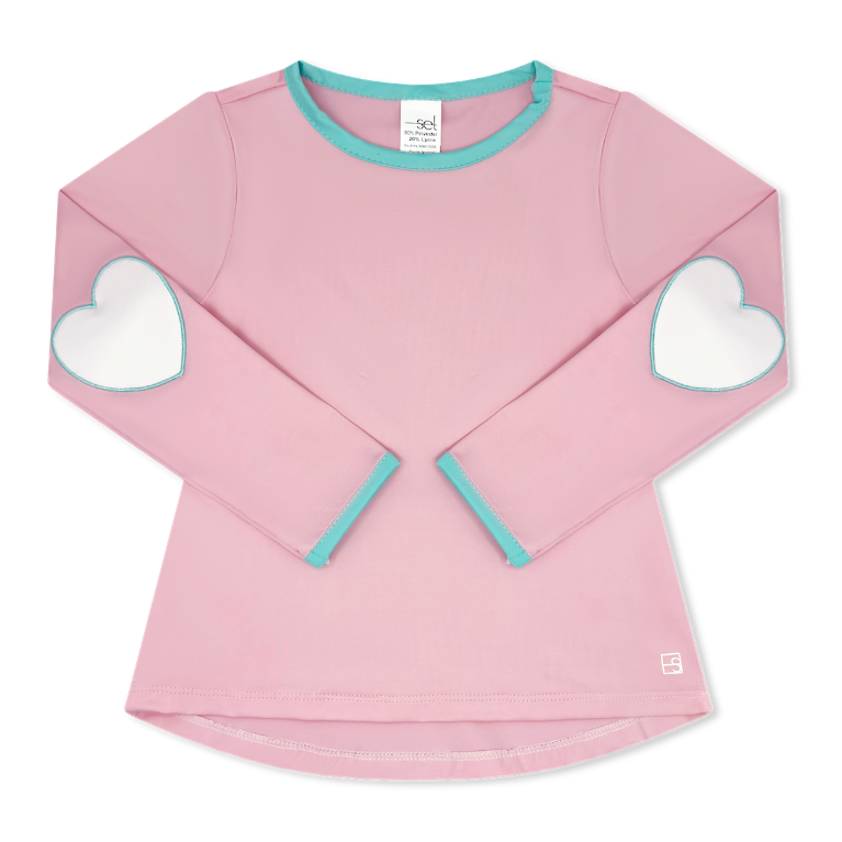 A pink long-sleeve top for kids with white heart patches on the elbows and light blue trim on the collar and cuffs, shown flat on a white background.