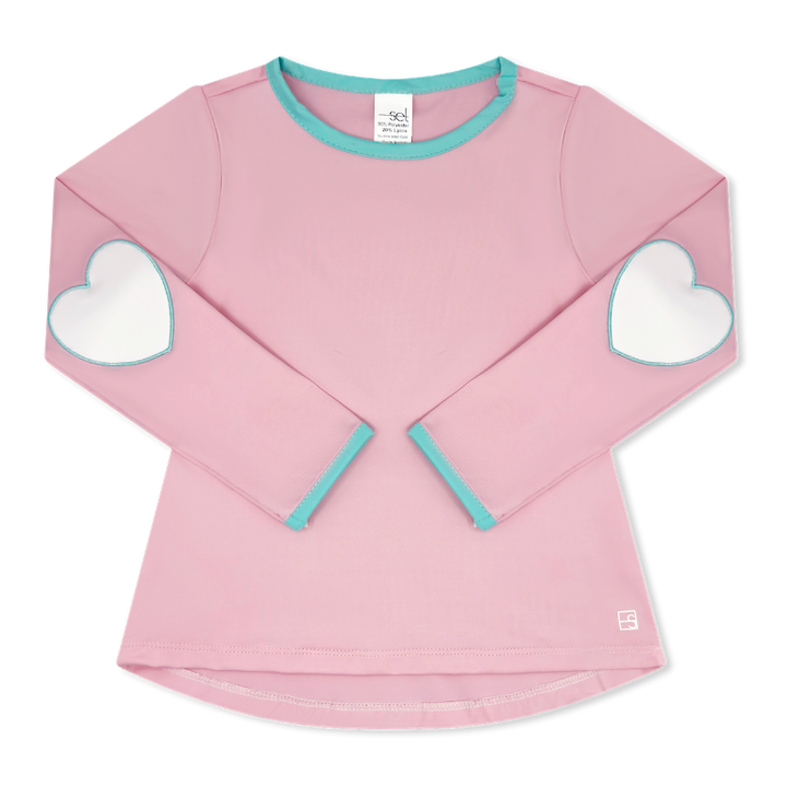 A pink long-sleeve top for kids with white heart patches on the elbows and light blue trim on the collar and cuffs, shown flat on a white background.