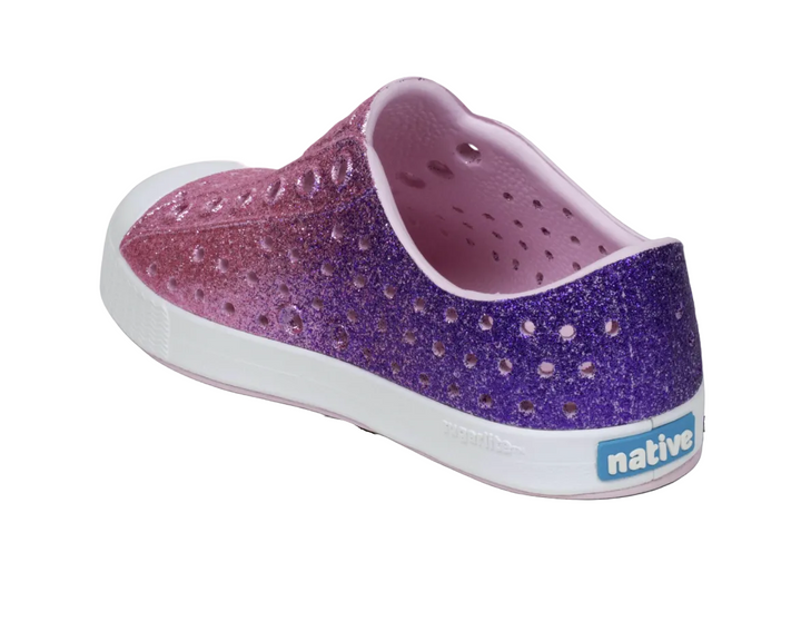 Purple and pink glittery shoe with 'native' branding on a gray background