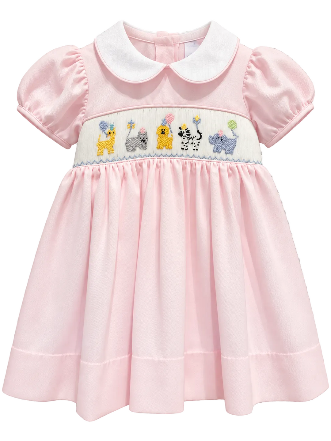 A pink baby dress with a white Peter Pan collar and a smocked chest panel featuring colorful embroidered animals, shown on a checkered transparency background.