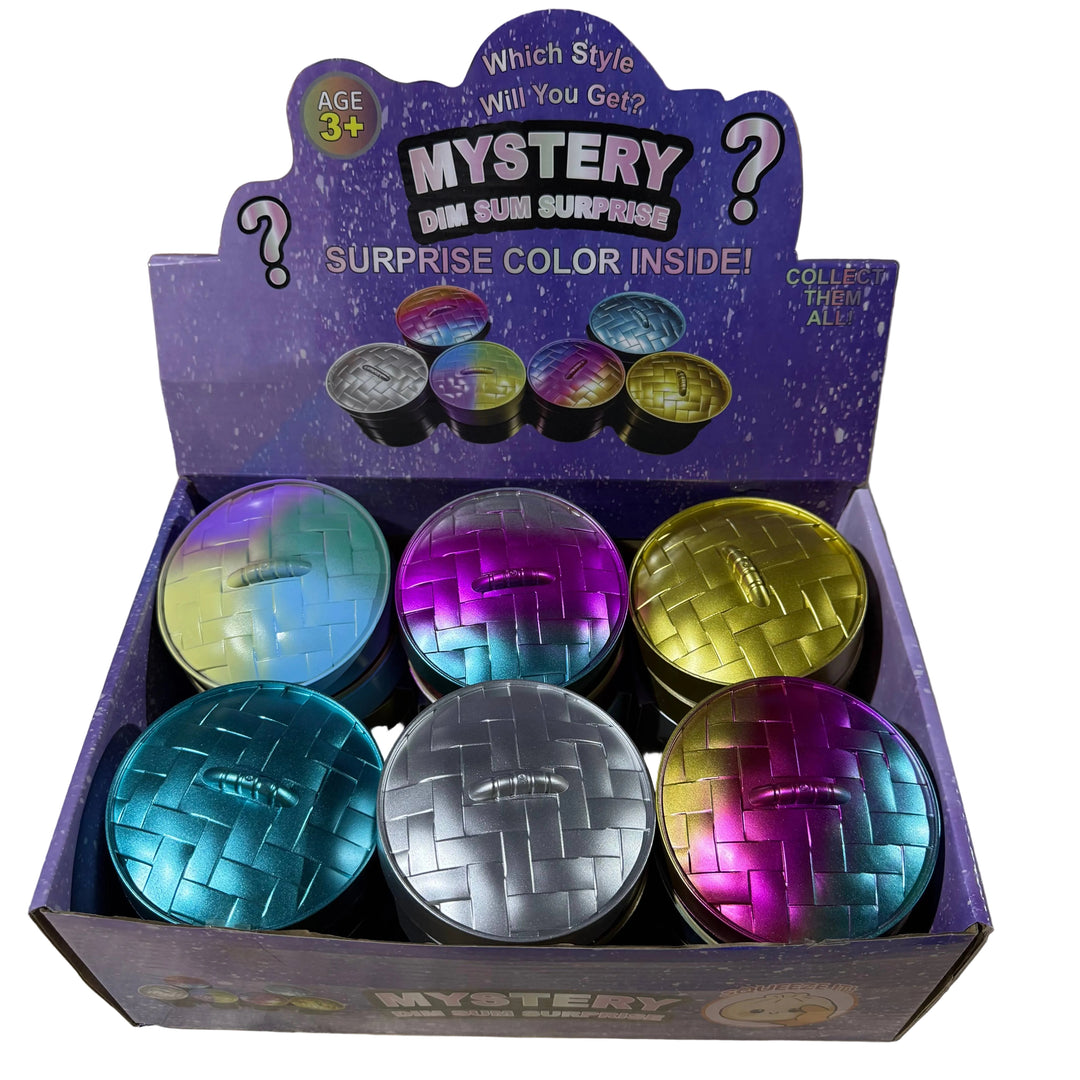 A retail display box of six round dumplings assorted metallic colors, with a purple header card reading Mystery Dim Sum Surprise 