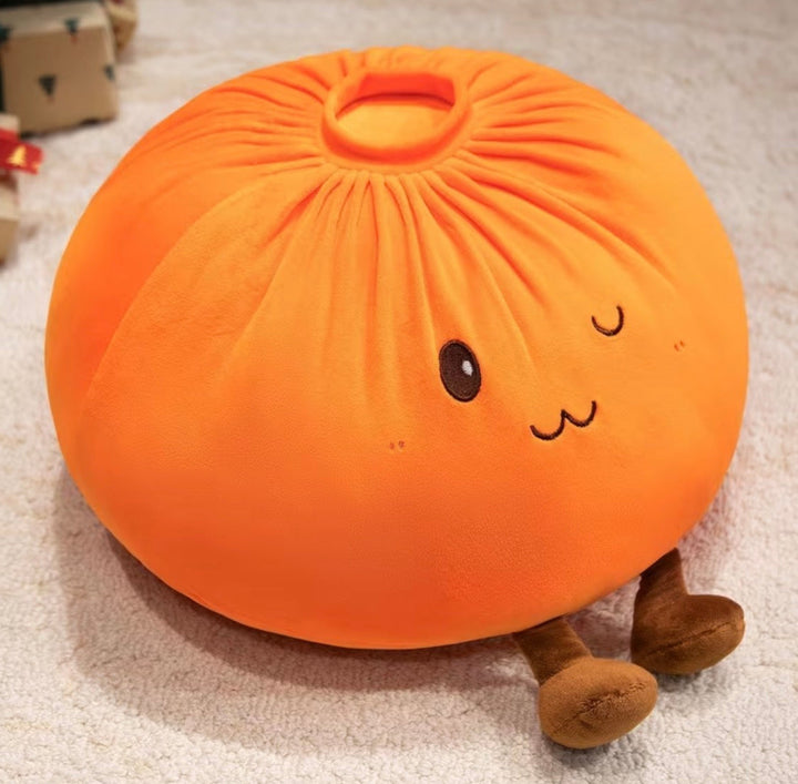 An orange plush pillow shaped like a cute steamed bun (baozi) with embroidered facial features and small brown legs, resting on a light beige carpet.