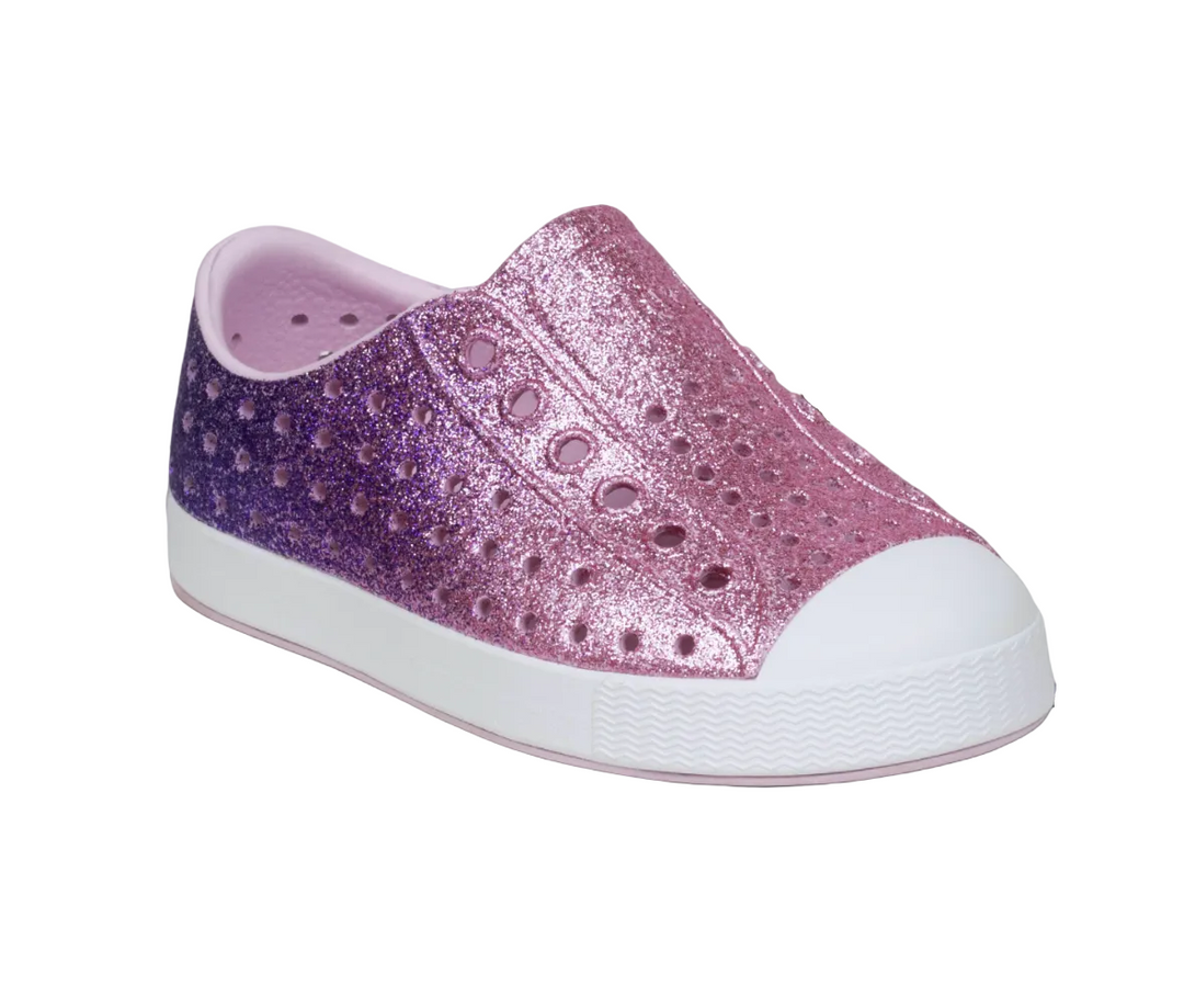 Pink glittery shoe with white sole on a gray background