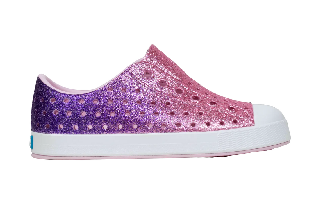 Glittery purple and pink shoe on a gray background