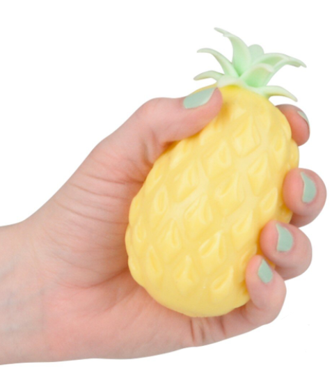 Hand holding a pineapple-shaped stress reliever toy with a white background