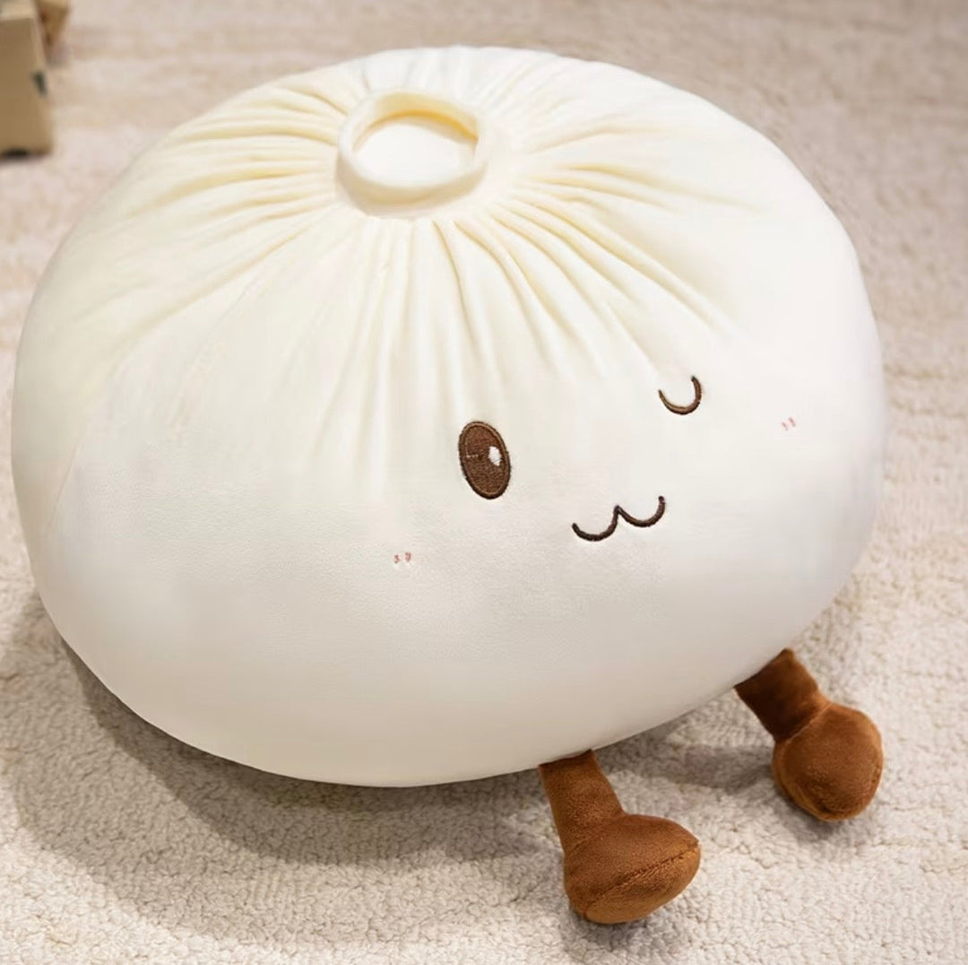 A cute, round plush pillow designed to look like a steamed bun (baozi) with embroidered facial features and small legs, resting on a beige carpet.