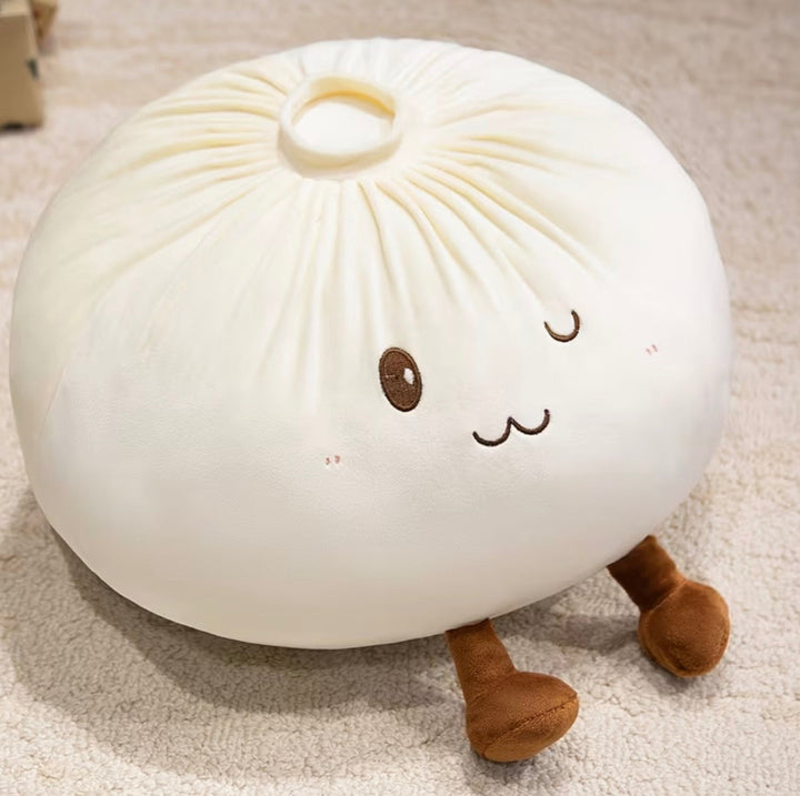 A cute, round plush pillow designed to look like a steamed bun (baozi) with embroidered facial features and small legs, resting on a beige carpet.